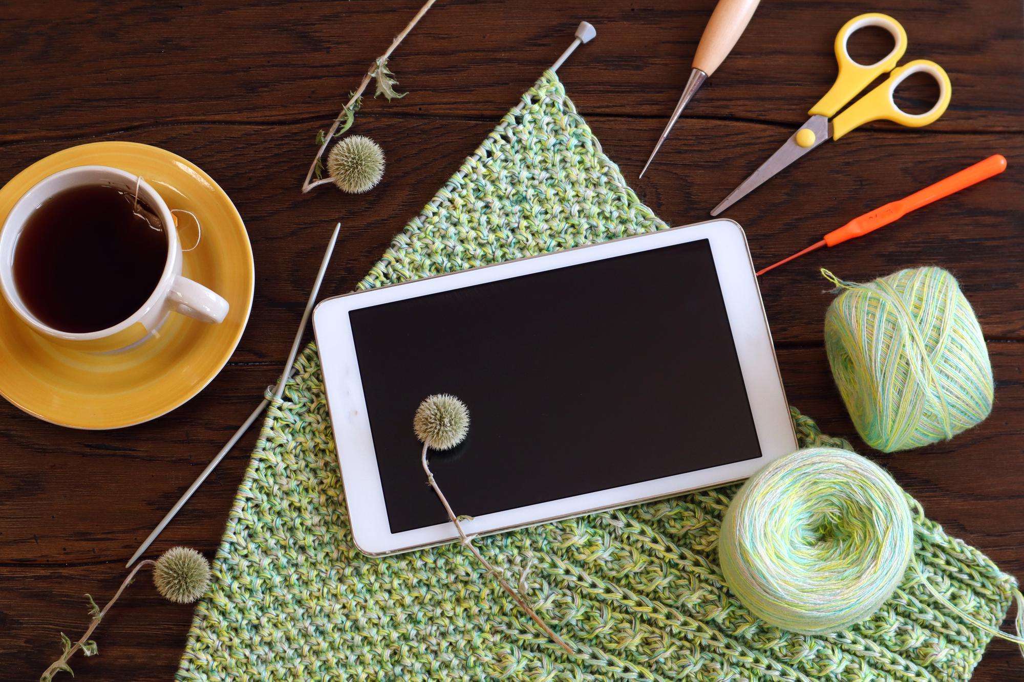 Studio workspace with hoops, threads and digital tablet